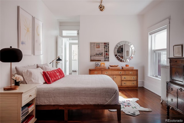 bedroom featuring dark hardwood / wood-style flooring