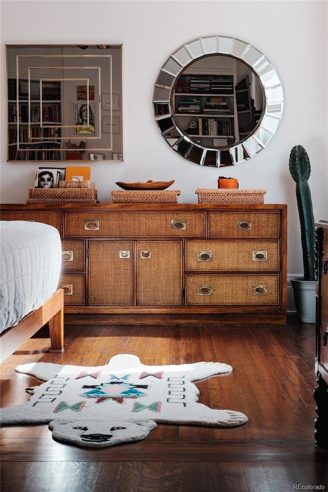 bedroom with dark hardwood / wood-style flooring