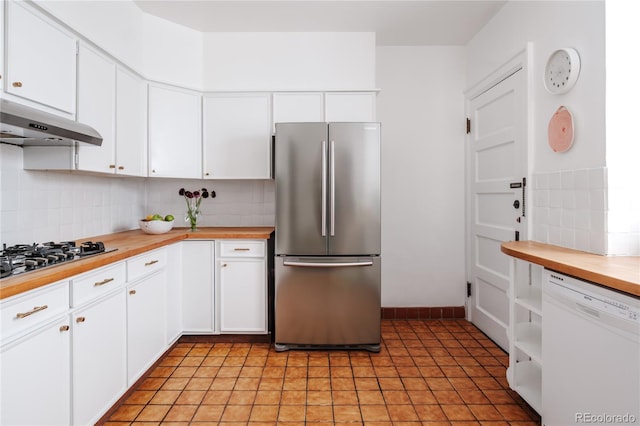 kitchen featuring tasteful backsplash, white cabinetry, wooden counters, and appliances with stainless steel finishes