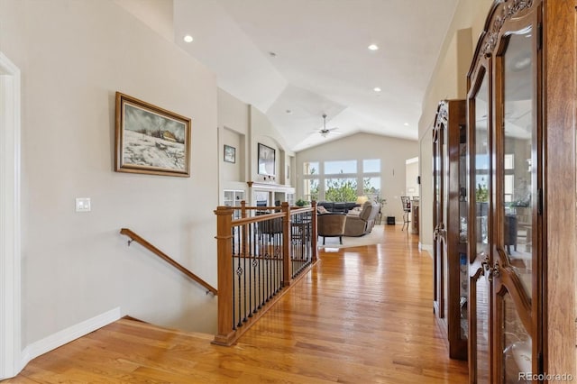 8714 E 148th Cir, Thornton, CO 80602 - hallway with an upstairs landing, light wood-style flooring, baseboards, and vaulted ceiling