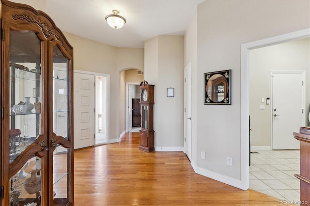 8714 E 148th Cir, Thornton, CO 80602 - entryway with visible vents, light wood-style flooring, arched walkways, and baseboards