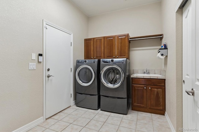 8714 E 148th Cir, Thornton, CO 80602 - laundry area with light tile patterned floors, baseboards, separate washer and dryer, a sink, and cabinet space