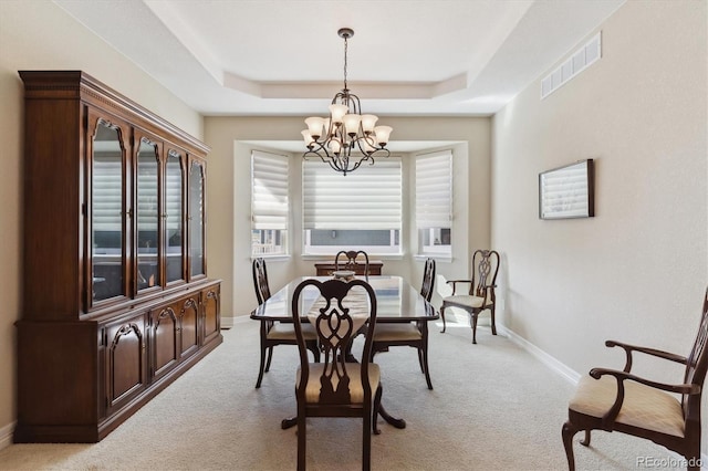 8714 E 148th Cir, Thornton, CO 80602 - dining room featuring a chandelier, light colored carpet, a tray ceiling, and visible vents