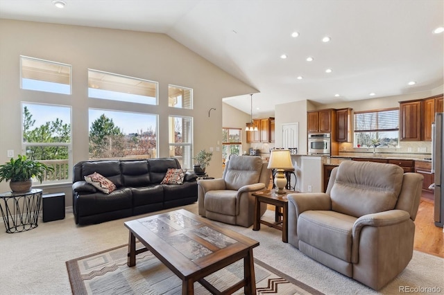 8714 E 148th Cir, Thornton, CO 80602 - living area with light colored carpet, vaulted ceiling, and recessed lighting