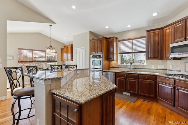 8714 E 148th Cir, Thornton, CO 80602 - kitchen featuring a sink, appliances with stainless steel finishes, a kitchen breakfast bar, and plenty of natural light