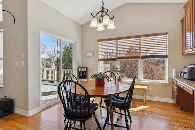 8714 E 148th Cir, Thornton, CO 80602 - dining space featuring a chandelier, light wood-type flooring, high vaulted ceiling, and baseboards