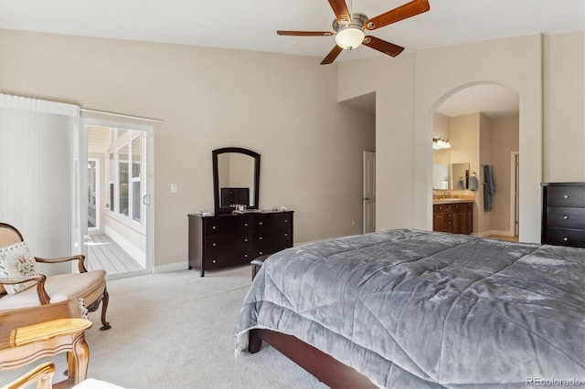 8714 E 148th Cir, Thornton, CO 80602 - bedroom featuring ensuite bathroom, baseboards, arched walkways, vaulted ceiling, and carpet flooring