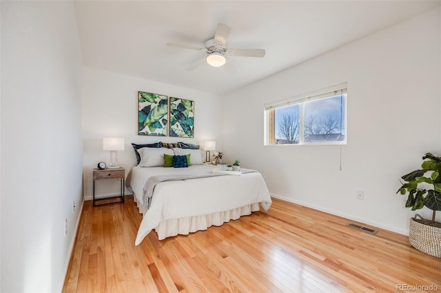 bedroom with wood-type flooring and ceiling fan