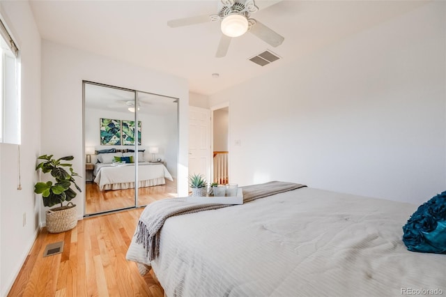 bedroom with hardwood / wood-style flooring, ceiling fan, and a closet