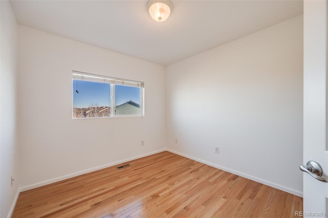 unfurnished room with light wood-type flooring