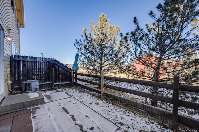 snow covered patio with cooling unit