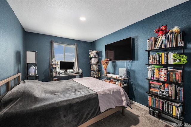 bedroom featuring carpet floors and a textured ceiling