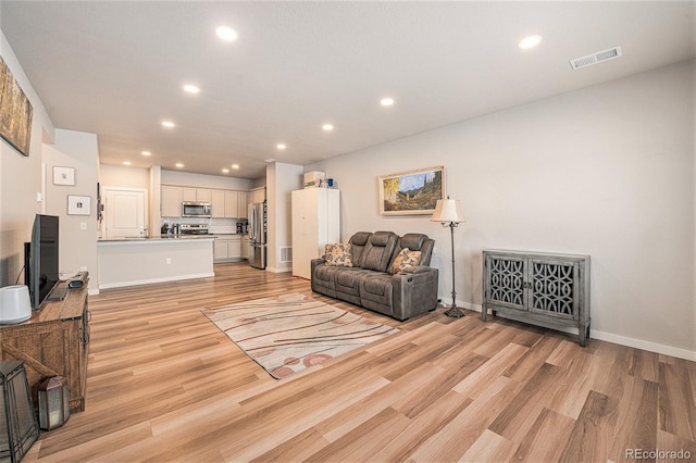 living room with light hardwood / wood-style flooring