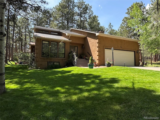 85 S Sherwood Gln, Monument, CO 80132 - view of front of property featuring a garage, concrete driveway, a front lawn, and stucco siding
