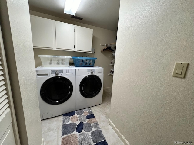 85 S Sherwood Gln, Monument, CO 80132 - washroom featuring washer and dryer, light tile patterned floors, cabinet space, and a textured wall