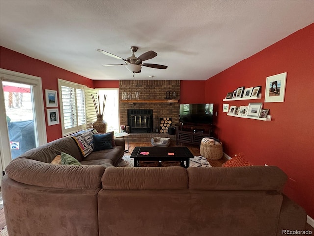 85 S Sherwood Gln, Monument, CO 80132 - living room featuring a ceiling fan, a brick fireplace, and wood finished floors