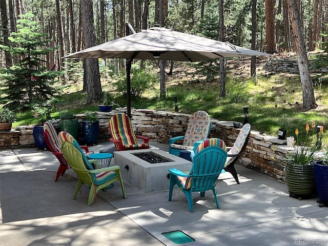 85 S Sherwood Gln, Monument, CO 80132 - view of patio featuring a fire pit and a wooded view