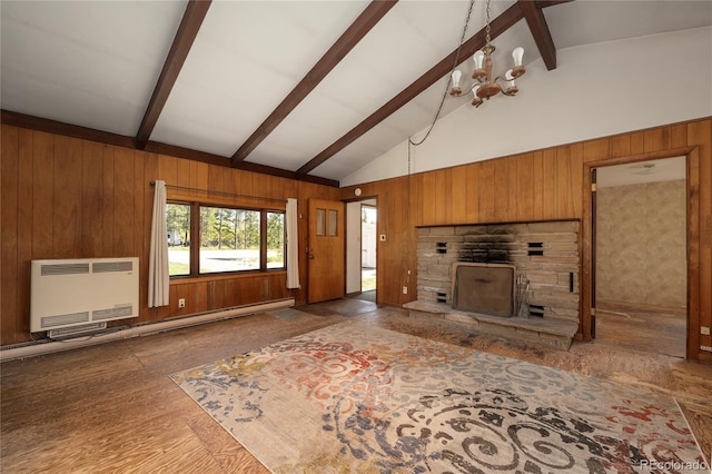 23976 County Rd 50, Fraser, CO 80442 - unfurnished living room with wood walls, heating unit, a stone fireplace, and wood finished floors