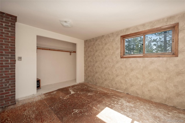 23976 County Rd 50, Fraser, CO 80442 - unfurnished bedroom featuring wallpapered walls and a closet
