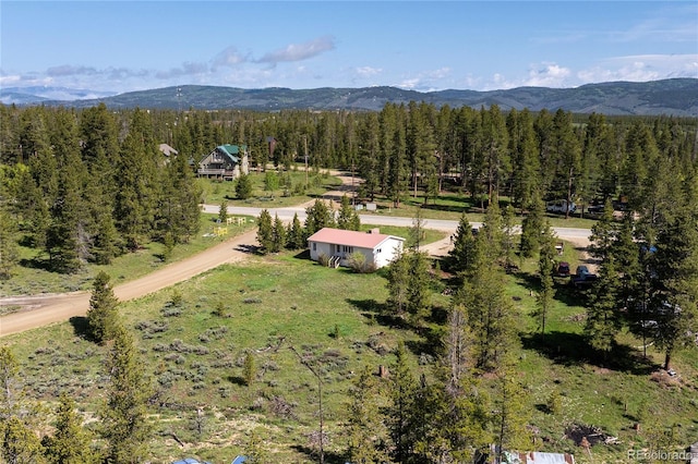 23976 County Rd 50, Fraser, CO 80442 - aerial view of property and surrounding area featuring a mountainous background and a heavily wooded area