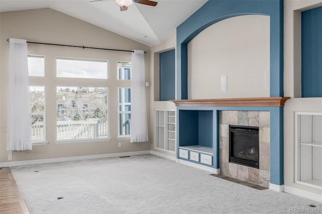 unfurnished living room featuring carpet floors, plenty of natural light, and a tile fireplace