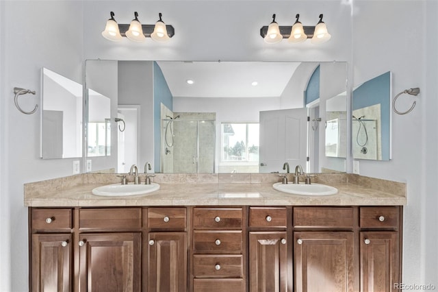 bathroom with double vanity, a shower stall, and a sink