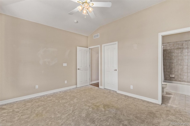 unfurnished bedroom featuring visible vents, vaulted ceiling, light carpet, and baseboards