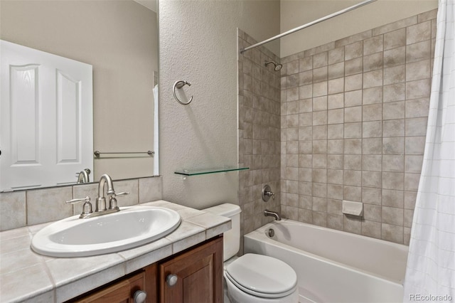 full bathroom featuring toilet, a textured wall, shower / bath combo with shower curtain, and vanity