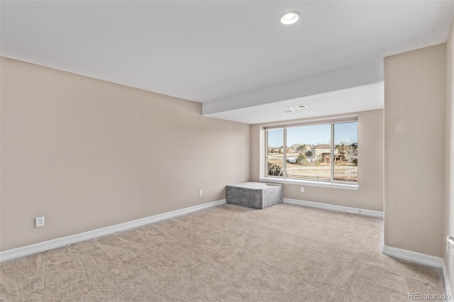 unfurnished room featuring recessed lighting, light colored carpet, and baseboards