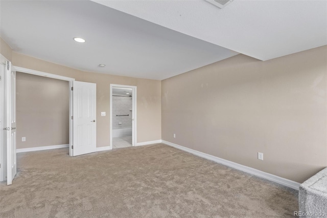 unfurnished bedroom featuring light carpet, visible vents, baseboards, ensuite bath, and recessed lighting