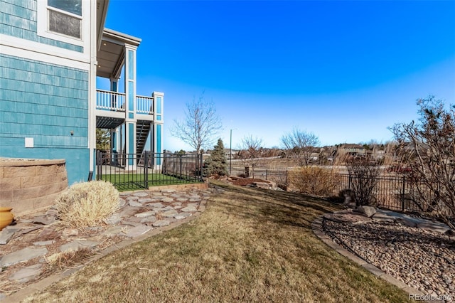 view of yard featuring stairs and a fenced backyard