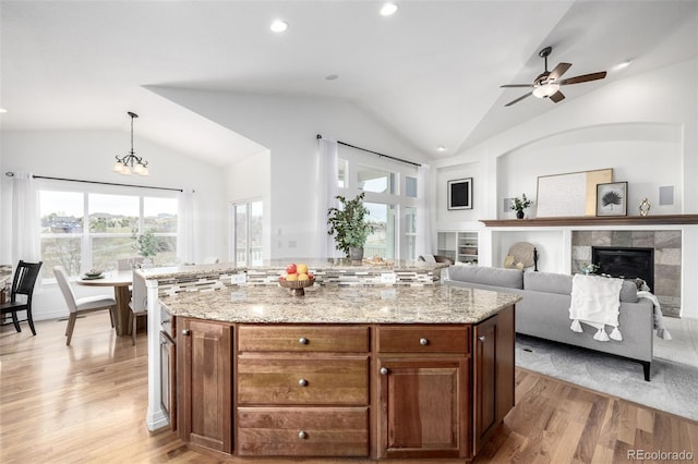 8802 E 148th Ln, Thornton, CO 80602 - kitchen with lofted ceiling, light wood finished floors, plenty of natural light, ceiling fan, and recessed lighting