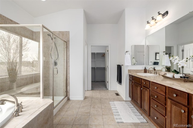 8802 E 148th Ln, Thornton, CO 80602 - full bath with a garden tub, vanity, a shower stall, a walk in closet, and tile patterned flooring