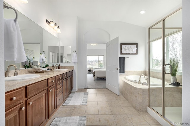 8802 E 148th Ln, Thornton, CO 80602 - ensuite bathroom with lofted ceiling, double vanity, a garden tub, and tile patterned flooring