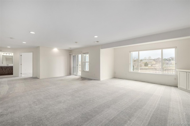 8802 E 148th Ln, Thornton, CO 80602 - unfurnished living room featuring light carpet and recessed lighting
