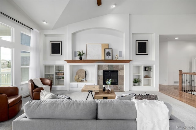 8802 E 148th Ln, Thornton, CO 80602 - living area featuring vaulted ceiling, a fireplace, a ceiling fan, wood finished floors, and built in features