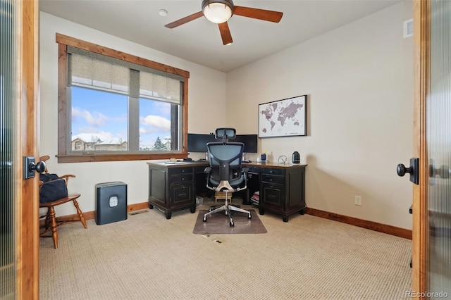 carpeted office space featuring ceiling fan