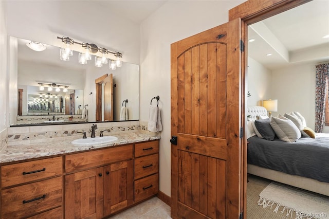 bathroom featuring tile patterned flooring, vanity, and backsplash