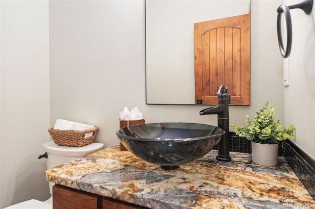 bathroom featuring vanity and toilet