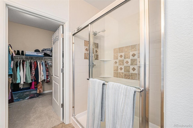 bathroom with a shower with door