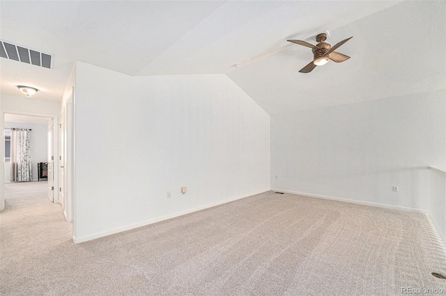 additional living space featuring ceiling fan, light colored carpet, and lofted ceiling