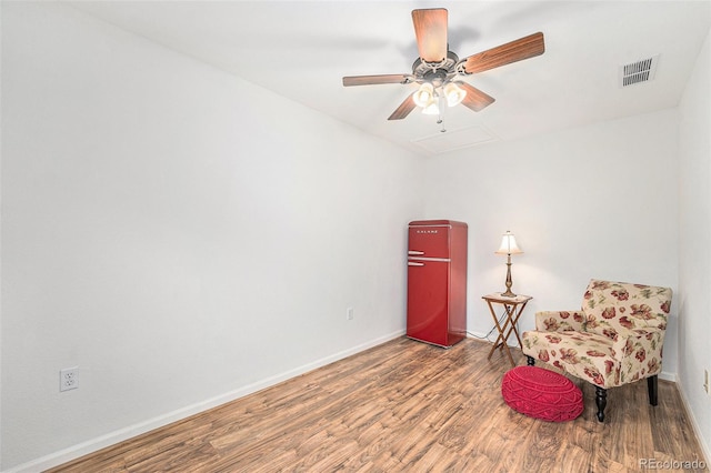 sitting room featuring hardwood / wood-style flooring and ceiling fan