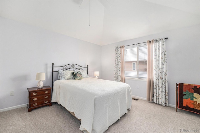 bedroom featuring light colored carpet and lofted ceiling