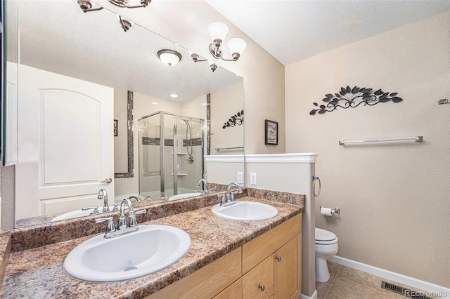 bathroom featuring walk in shower, tile patterned floors, a textured ceiling, toilet, and vanity