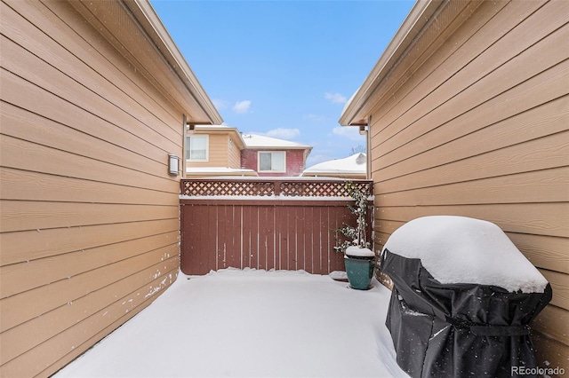 snow covered patio featuring a grill