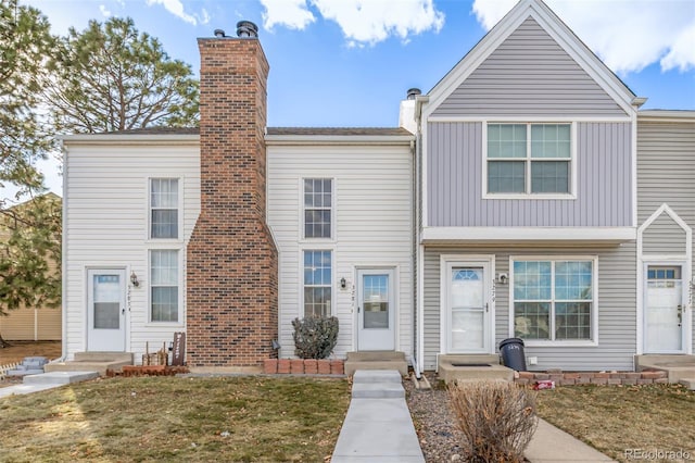 view of property with entry steps and a chimney