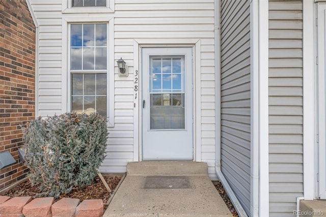 entrance to property featuring brick siding