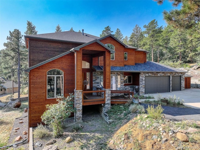 view of front of house with a wooden deck and a garage