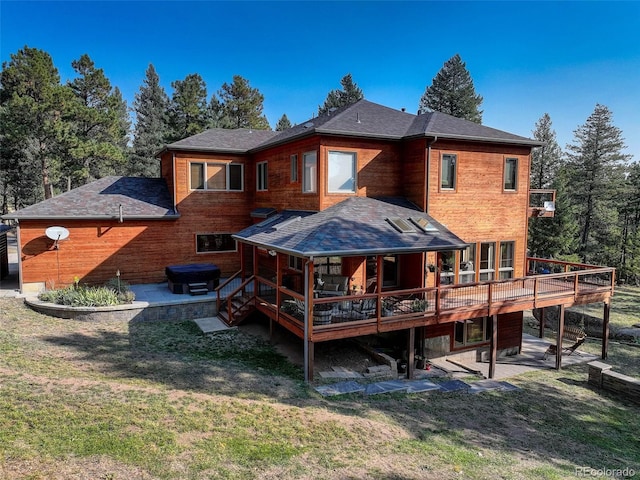 rear view of property featuring a patio area, a deck, and a yard