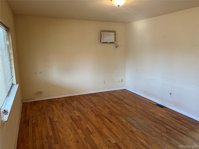 unfurnished room with hardwood / wood-style flooring